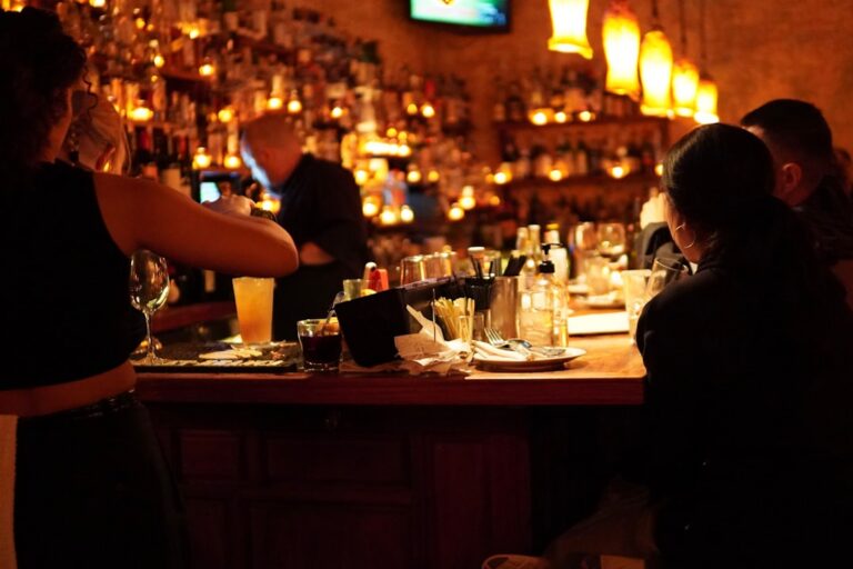 Bar owner reviewing receipts and bills at the counter after closing