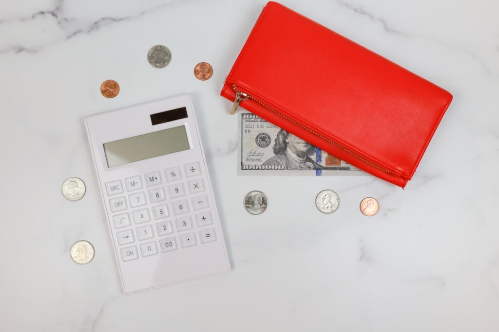 Small business owner using a calculator over financial documents