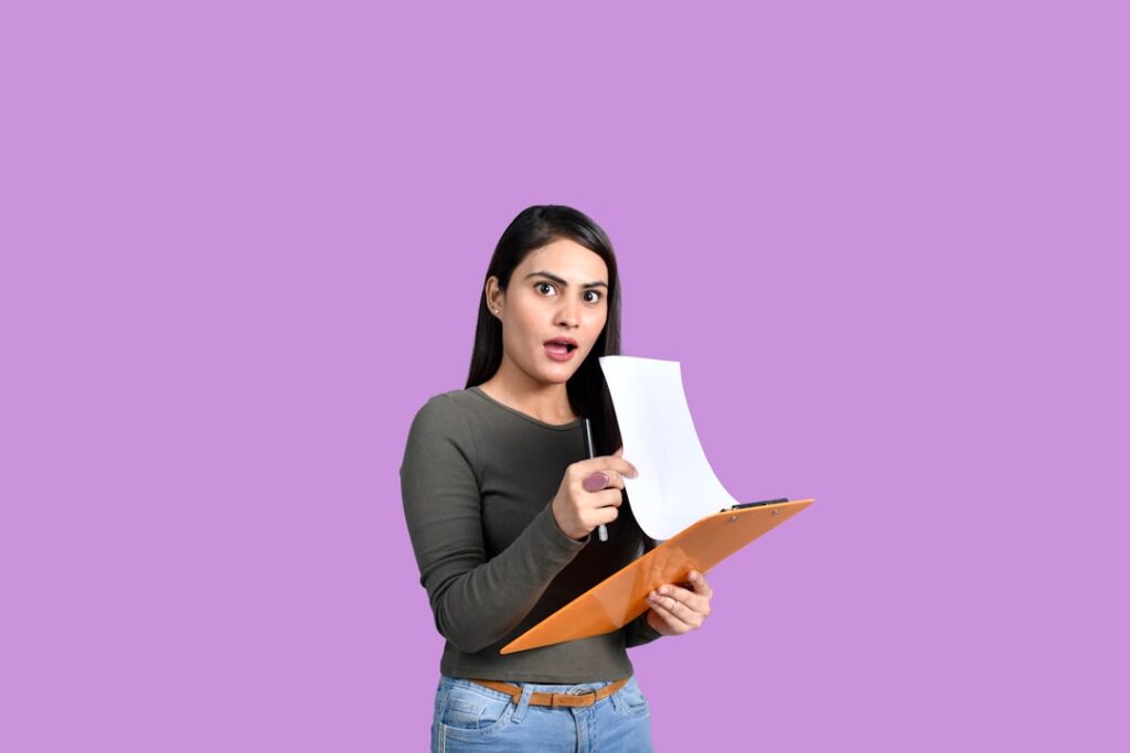 Small business owner reviewing MCA contract paperwork at a desk with a skeptical expression