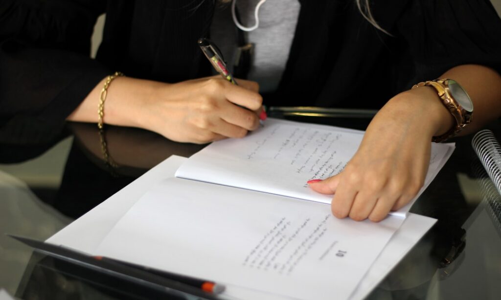 Close-up of a business owner's pen on the dispute resolution section of a contract