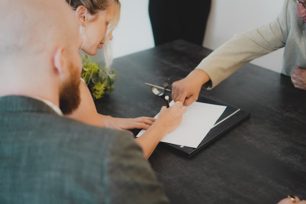 Close-up of hands reviewing and signing a financing contract