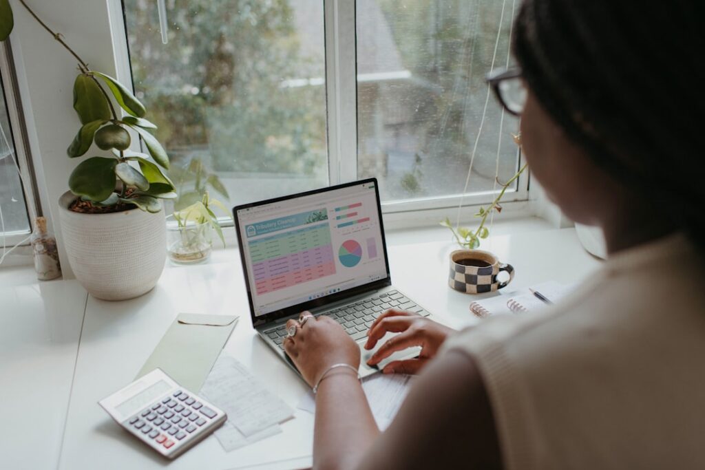 Business owner reviewing mid-year financial statements and cash flow charts