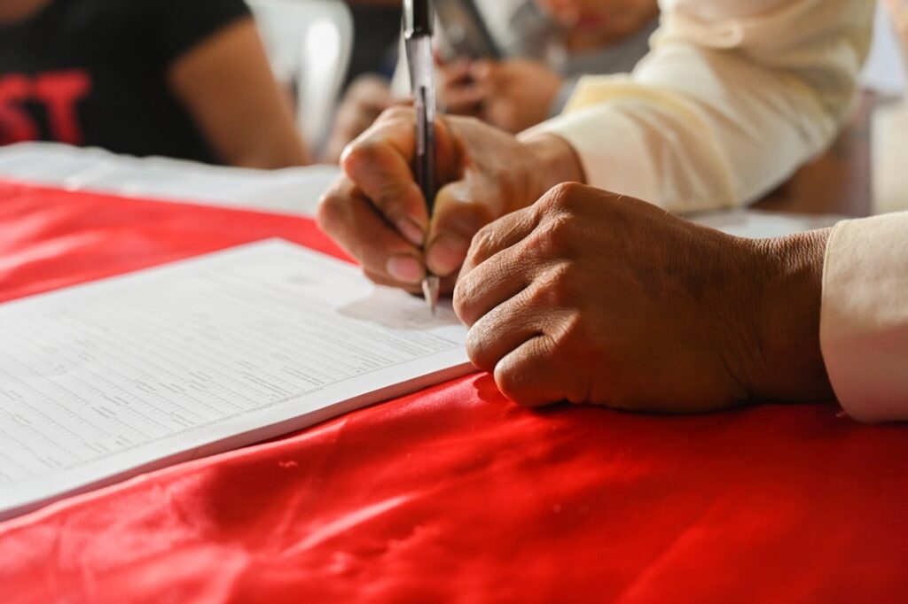 Close-up of hands signing a merchant cash advance agreement