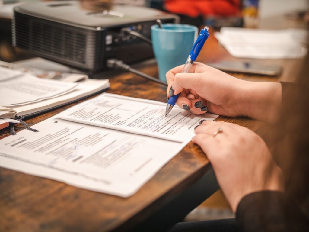 Small business owner filling out federal disaster loan paperwork at a desk