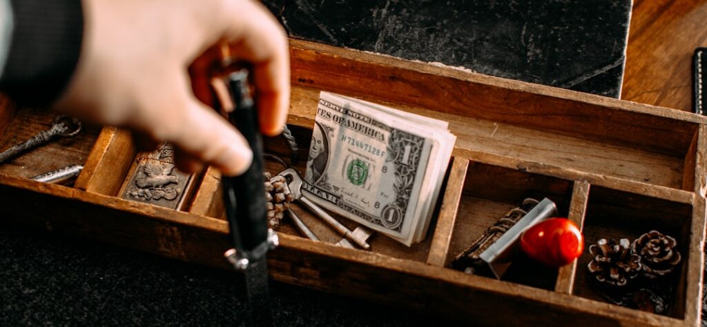 Nearly empty cash register drawer representing squeezed merchant cash flow