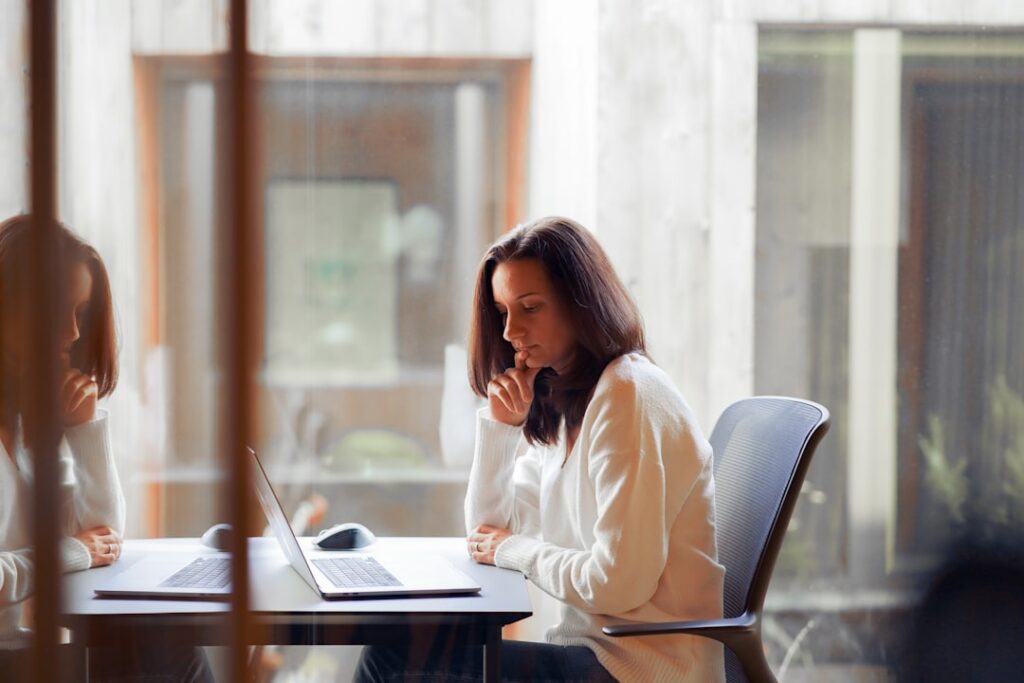 Business owner on a phone call negotiating while reviewing documents on the desk