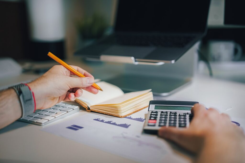 Calculator and financial statements laid out on a desk for a cash flow review