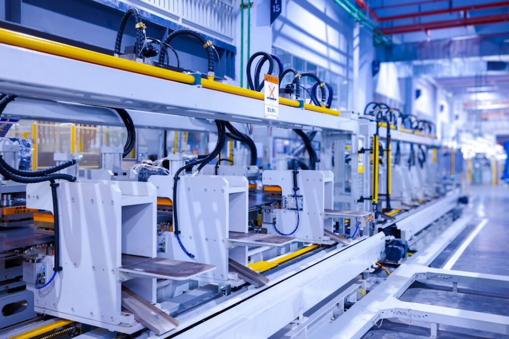 Manufacturing equipment on a factory floor with financing paperwork on a clipboard nearby