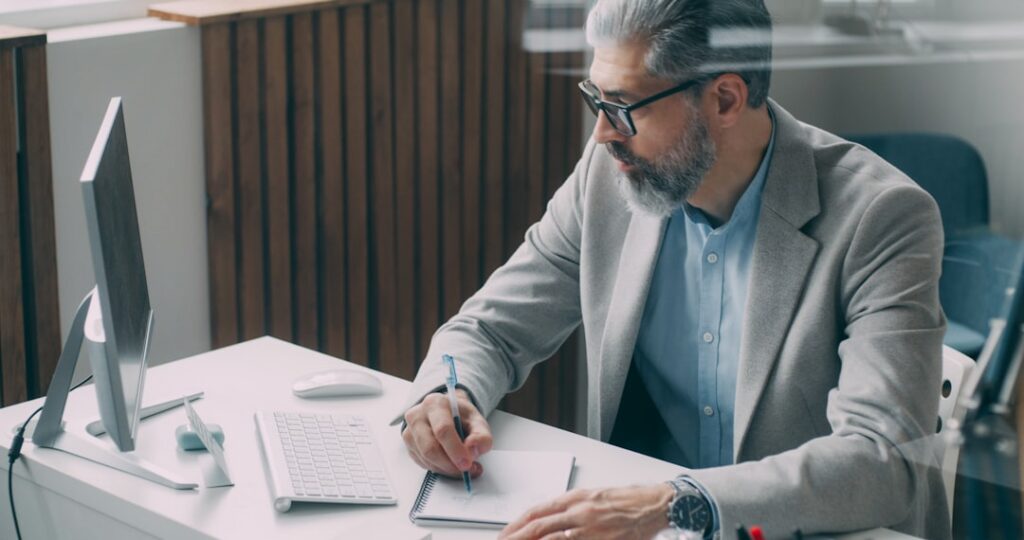 Business owner carefully examining fine print on an MCA forbearance contract before signing
