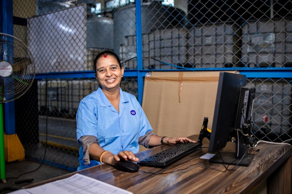 E-commerce warehouse worker packing shipping boxes during a high-volume sales season