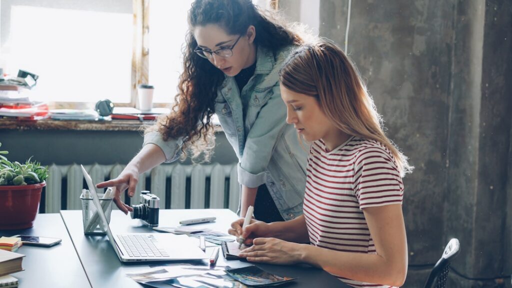 Small business owner and financial advisor reviewing documents together at a table
