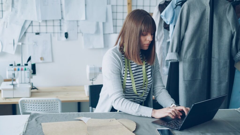 Small business owner reviewing a chargeback notice next to a laptop showing sales dashboard
