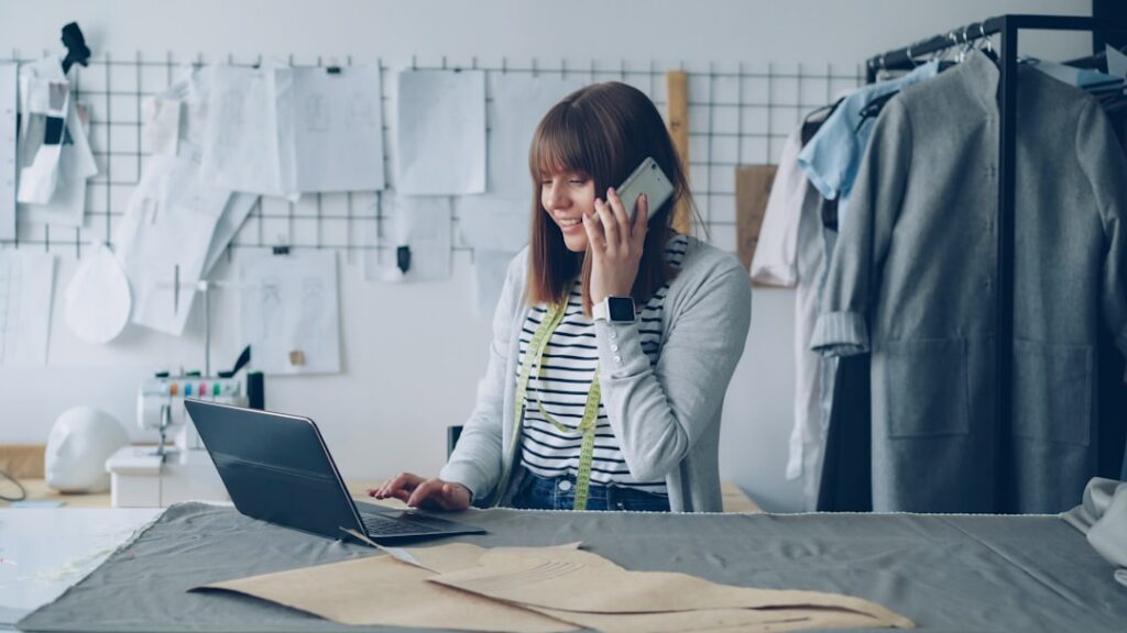 Business owner on a phone call while reviewing financial paperwork at a desk