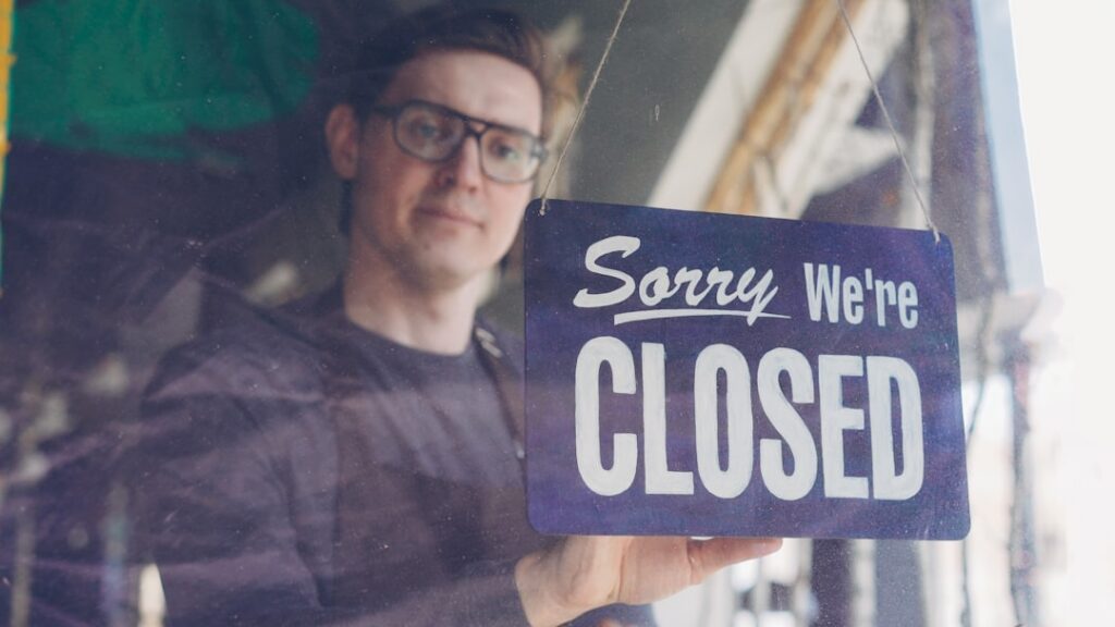 Small business owner unlocking and reopening the shop door after a storm