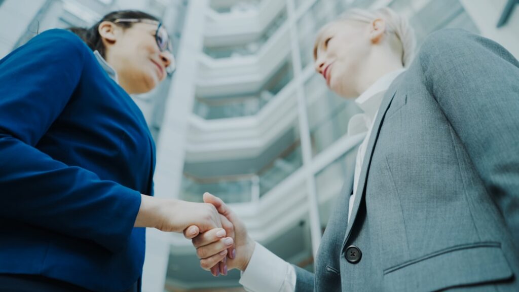 Handshake sealing a debt settlement agreement in a small office