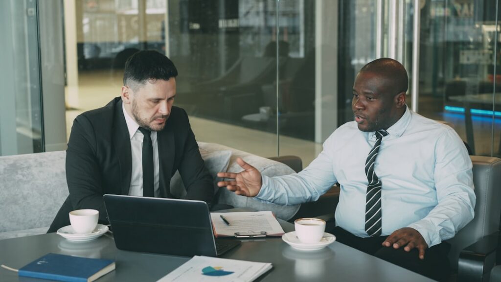 Handshake across a desk after finalizing a business agreement