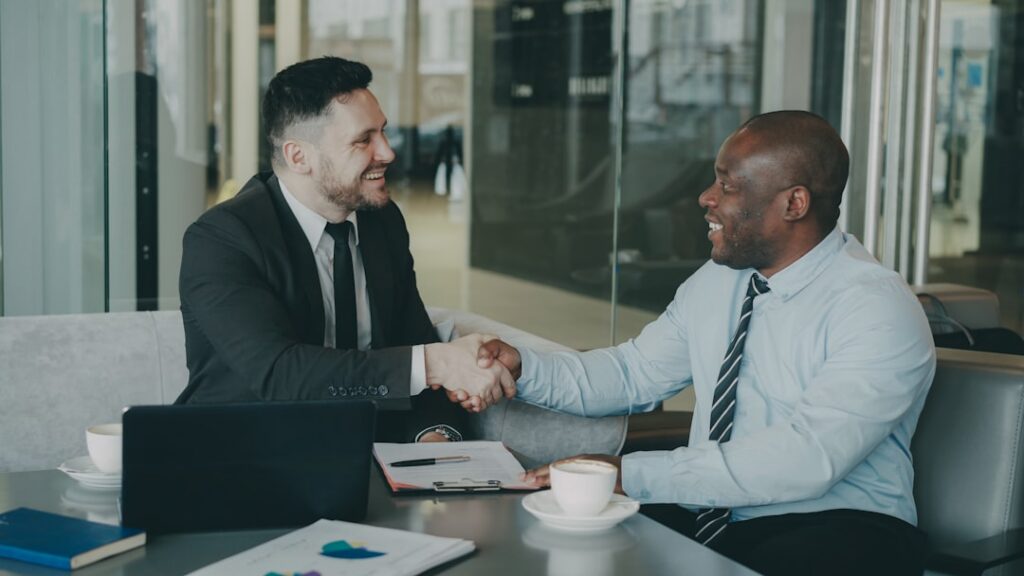 Business owner shaking hands with an advisor after reaching an agreement