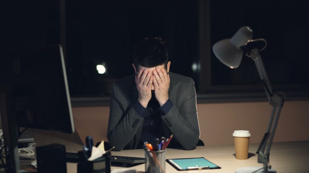 Business owner comparing several merchant cash advance offer letters at a desk