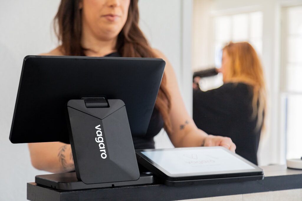 Small business owner signing a financing contract across a desk