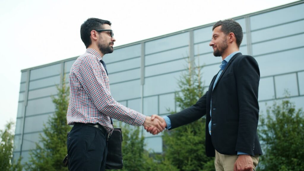 Handshake sealing a negotiated MCA settlement agreement
