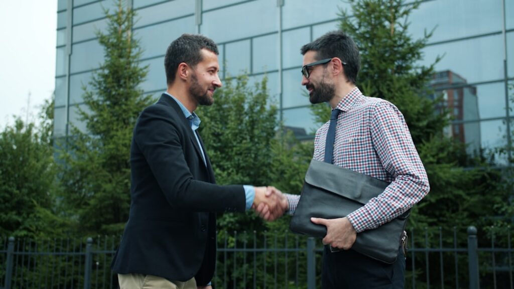 Business owner and specialist shaking hands after reaching a negotiated settlement