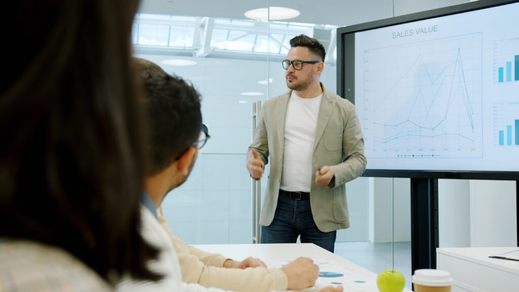 Business owner presenting an enrollment data chart during a meeting