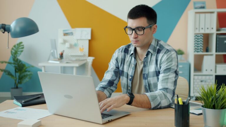 Retail store owner reviewing inventory costs and MCA debt on laptop