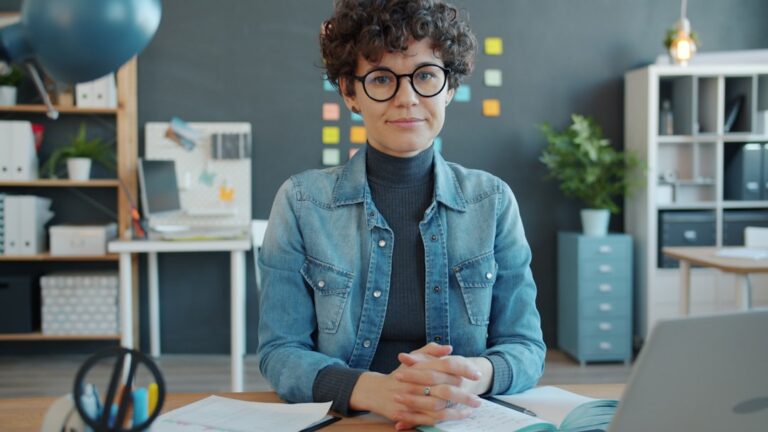 Business owner reviewing a stack of invoices and financing paperwork at a desk