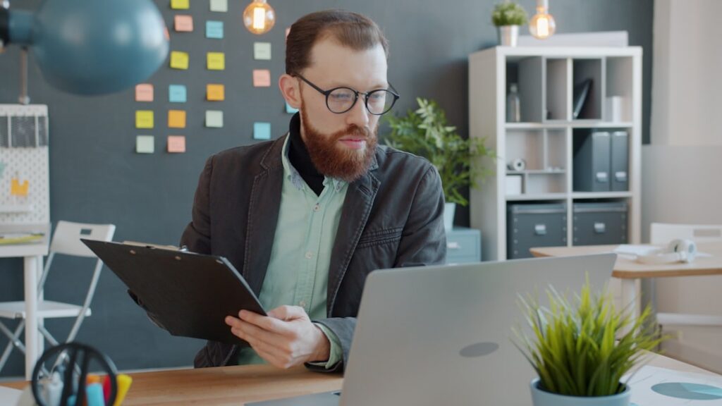 Small business owner reviewing government contract paperwork at a desk