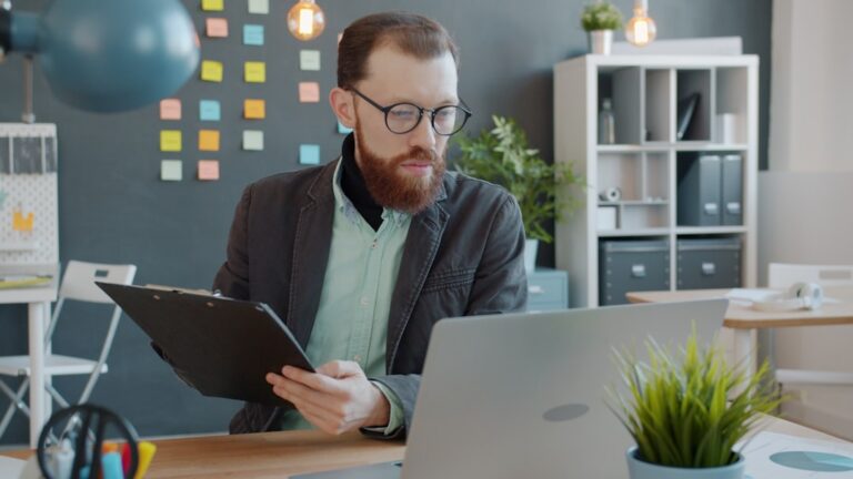 Small business owner reviewing government contract paperwork at a desk
