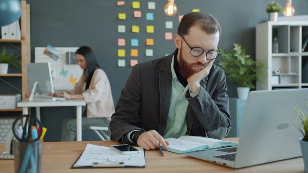 Business owner reviewing a spreadsheet and financial documents at a desk