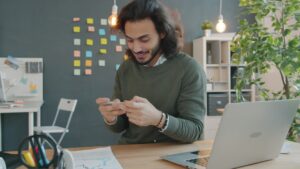 Small business owner reviewing financial documents and bank statements under pressure