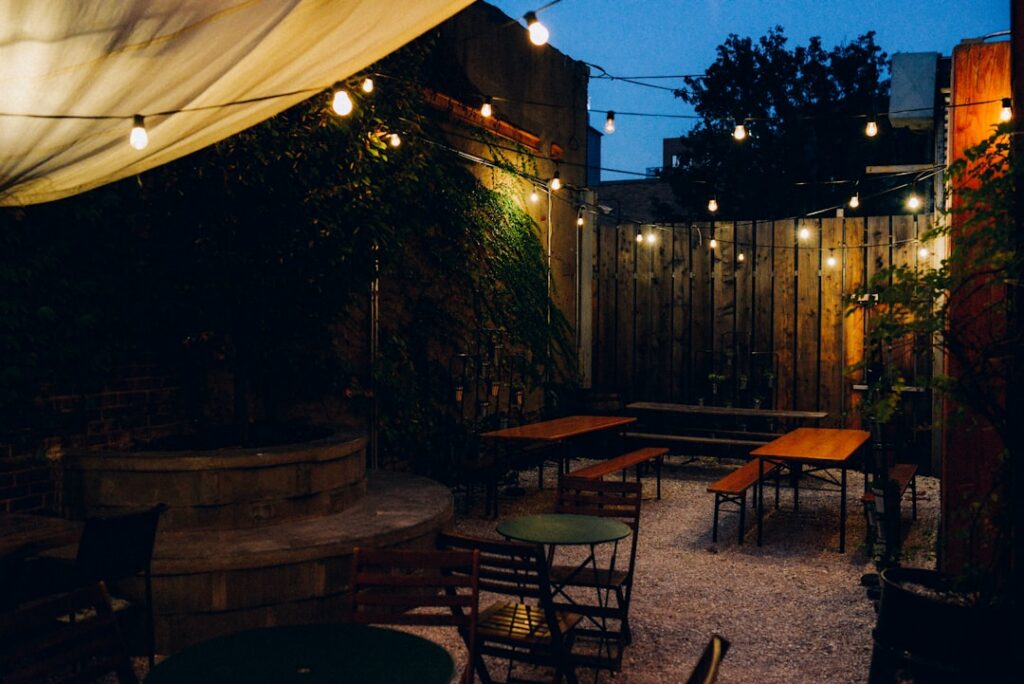 Crowded brewery taproom patio full of customers on a summer evening