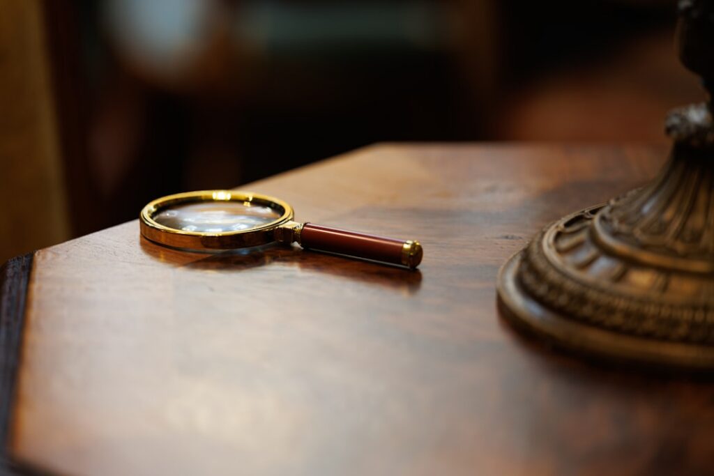 Magnifying glass over a contract, highlighting fine print and guarantees