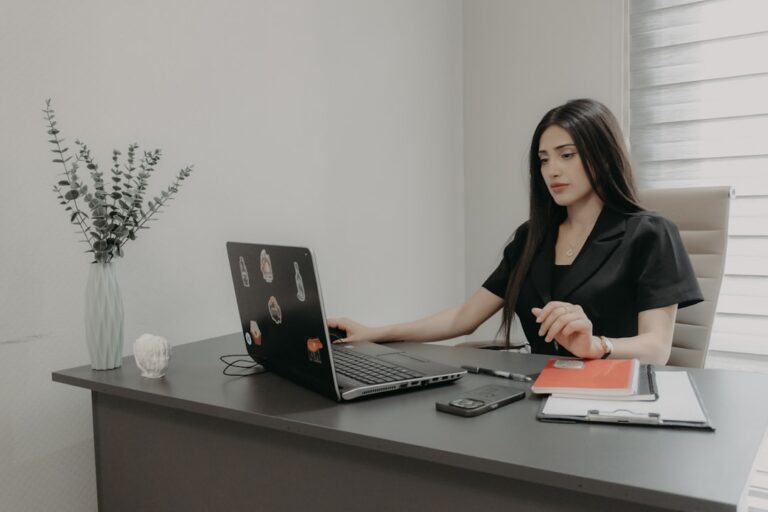 Staffing agency owner reviewing payroll and MCA debt documents at office desk