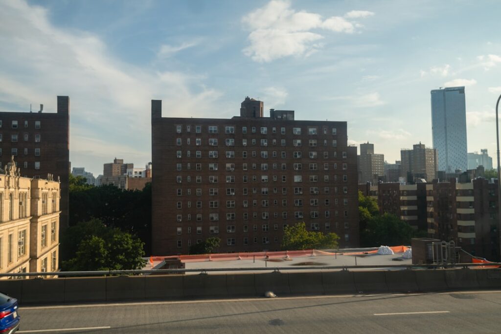 Movers loading a truck outside an apartment building during peak summer moving season