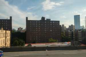 Movers loading a truck outside an apartment building during peak summer moving season