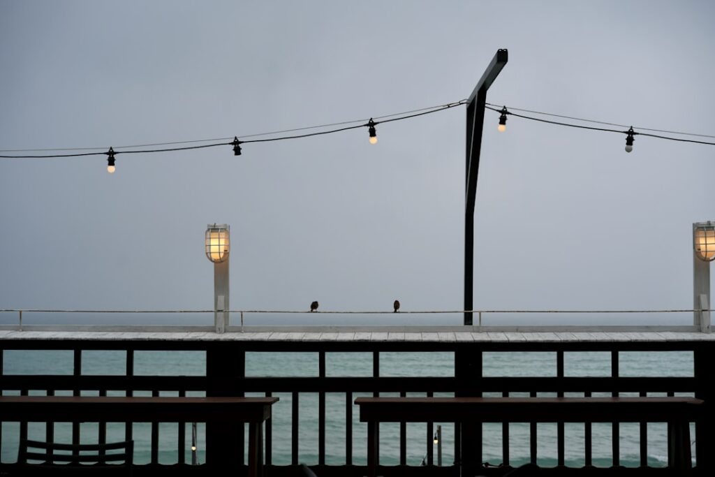 Coastal restaurant owner securing outdoor furniture ahead of storm season