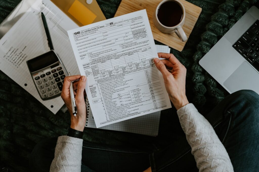 Business owner calculating multiple stacked cash advance payments on a calculator