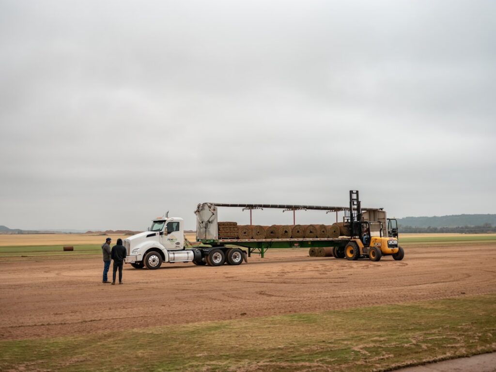 Small business owner standing next to a work truck while reviewing financing documents