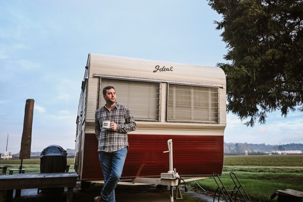 Camp owner outdoors on the phone, confident after resolving business debt