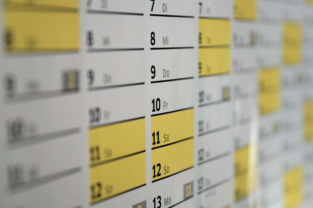 Office wall calendar with several dates circled in red marker