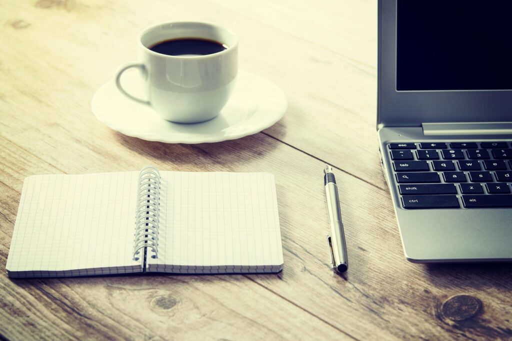Business invoice and remittance envelope sitting on a wooden desk
