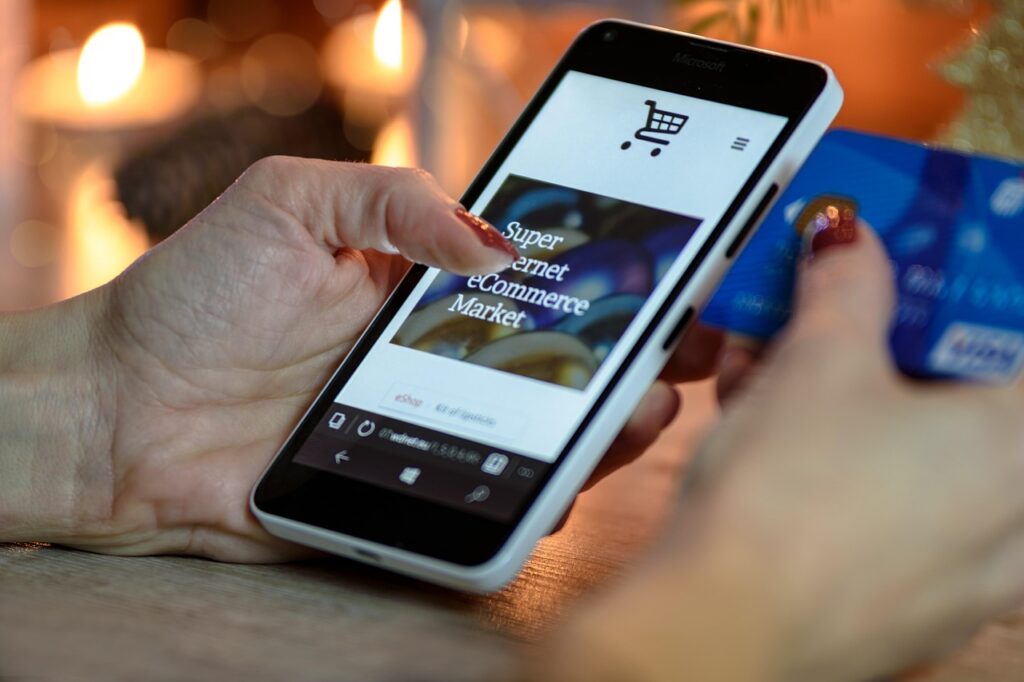 Close-up of a credit card being swiped through a terminal in a small shop