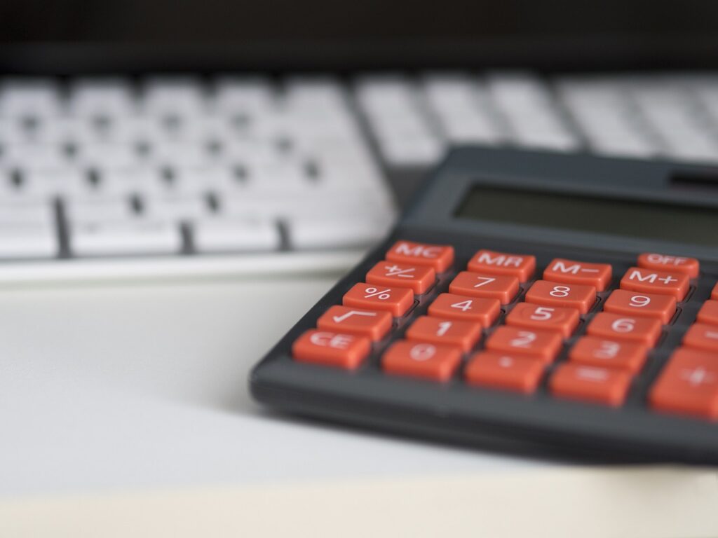Calculator and cash register receipts used to track daily revenue