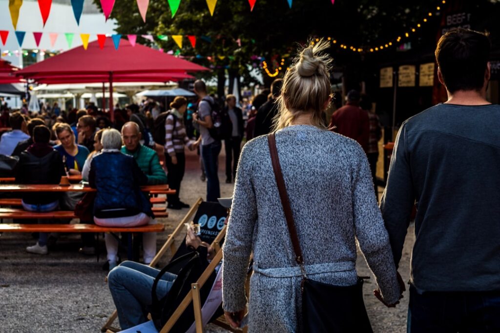 Outdoor fall festival with food truck vendor stalls and crowds