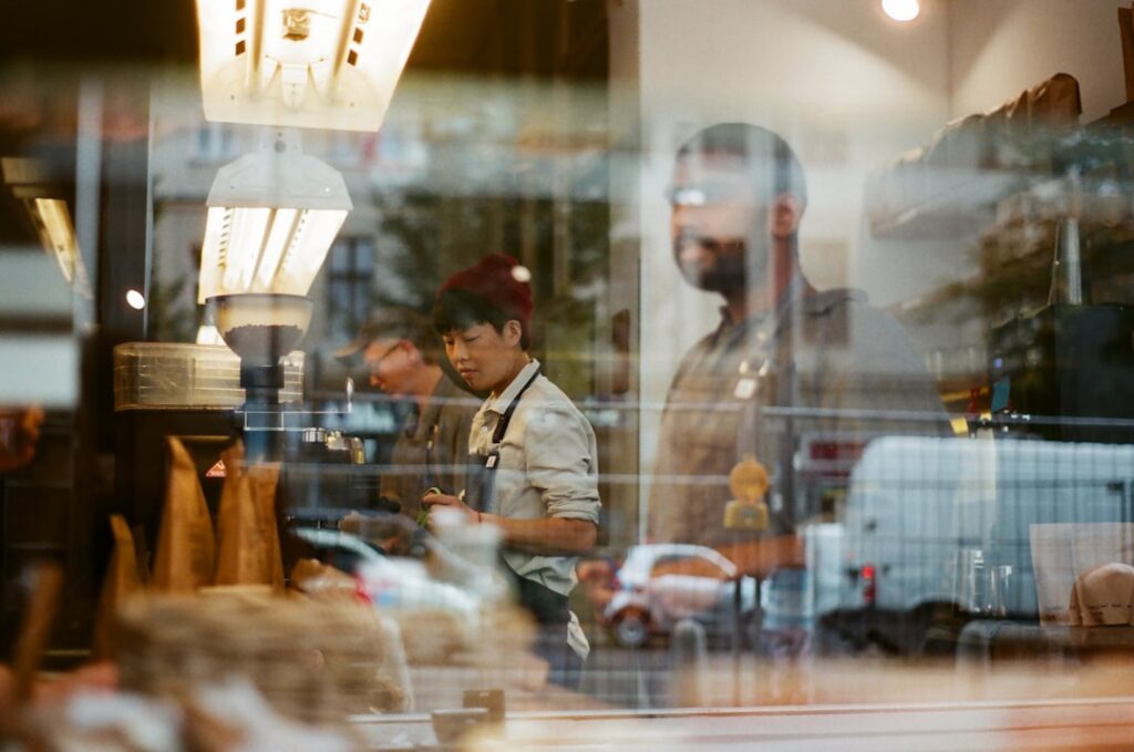 Food truck owner processing a card payment at the service window