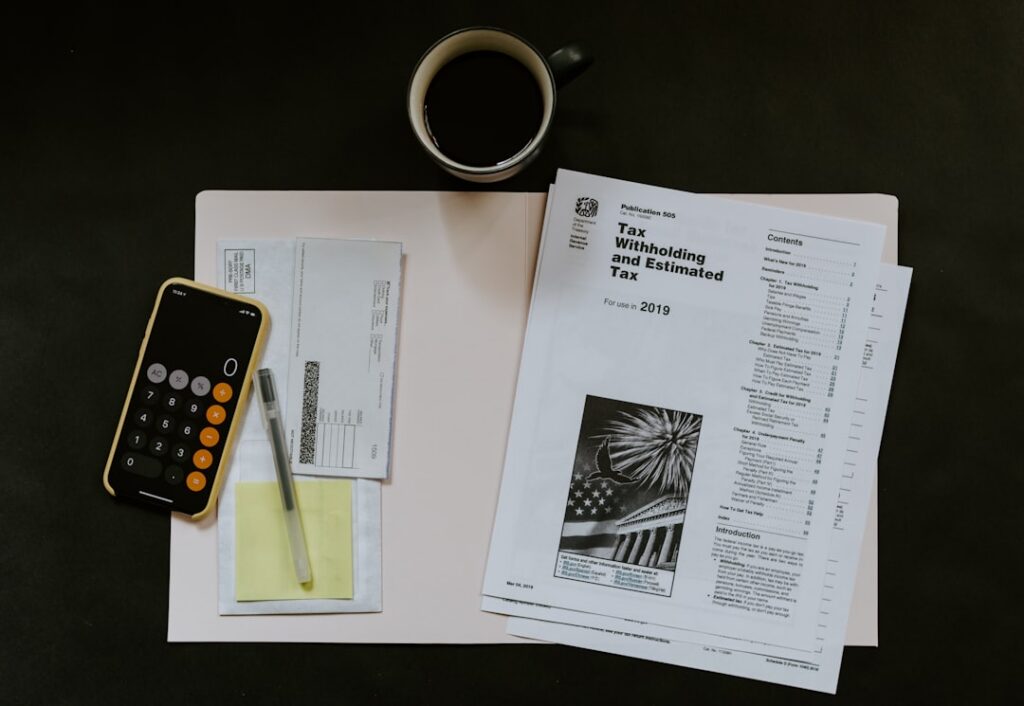 Bank statements and a paper ledger spread across a table