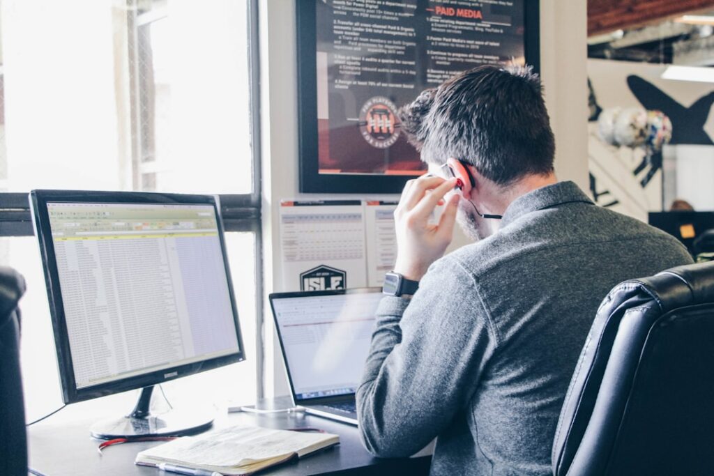 Small business owner reviewing bank statement deposits at a desk