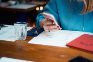 Small business owner reviewing customs and shipping paperwork at a desk